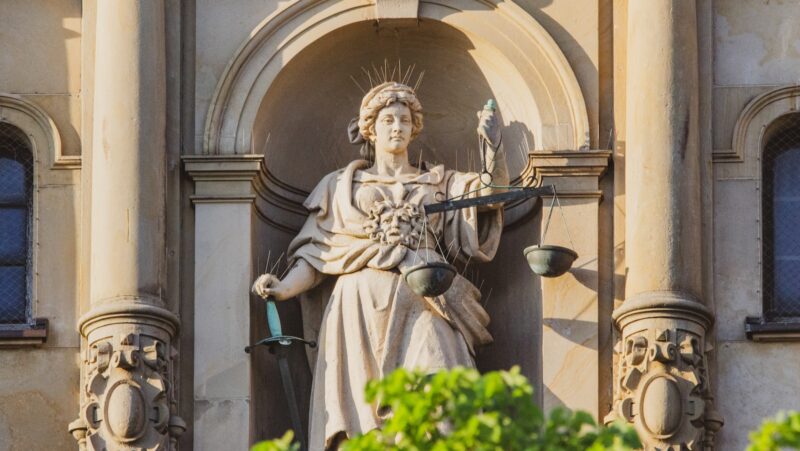 statue of man holding cross